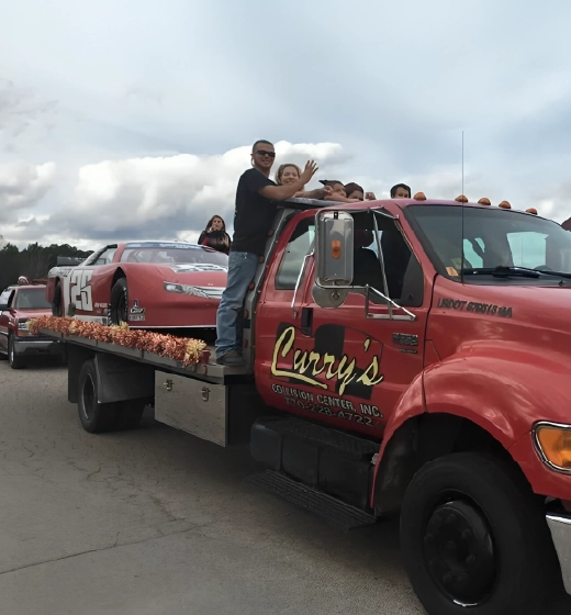 Tow truck carrying racecar