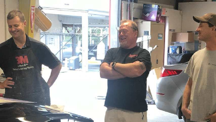 Smiling auto shop team