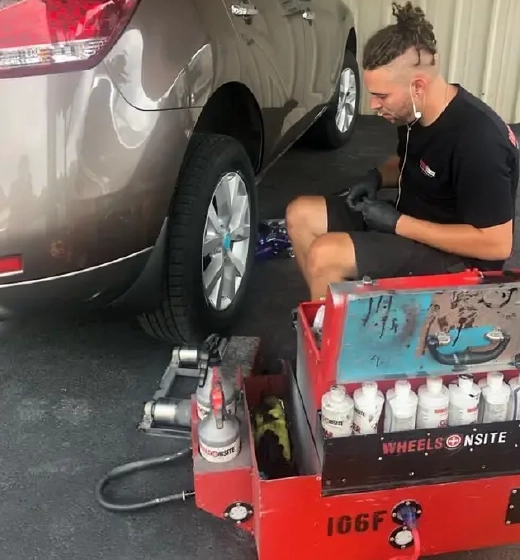 Mechanic repairing car wheel