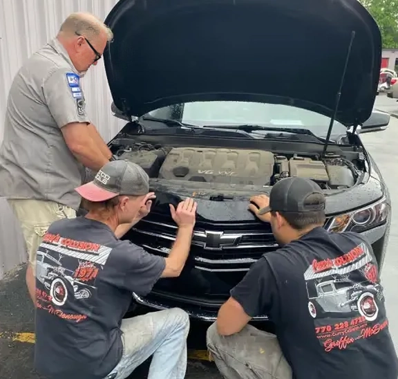 Mechanics inspecting car engine